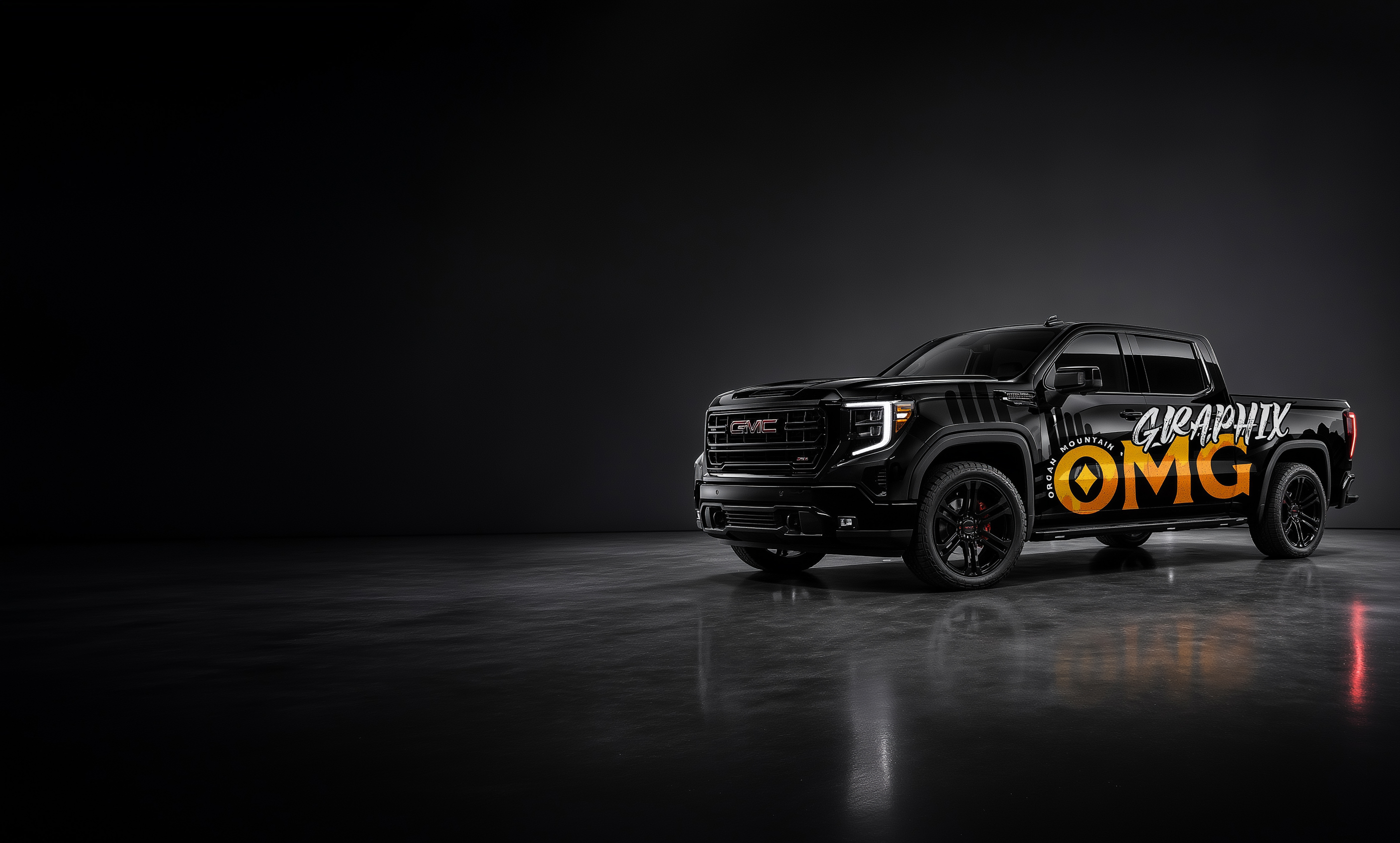 Black GMC Sierra wrapped with Organ Mountain Graphix branding